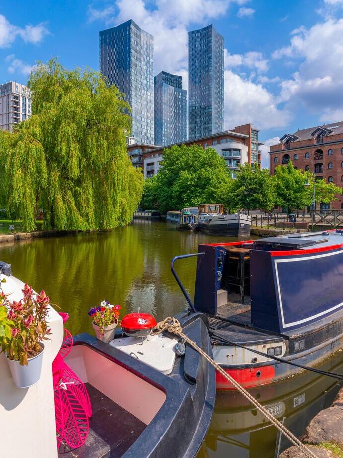 View of canal boat and contemporary skyline from Castlefield, Castlefield Canal.