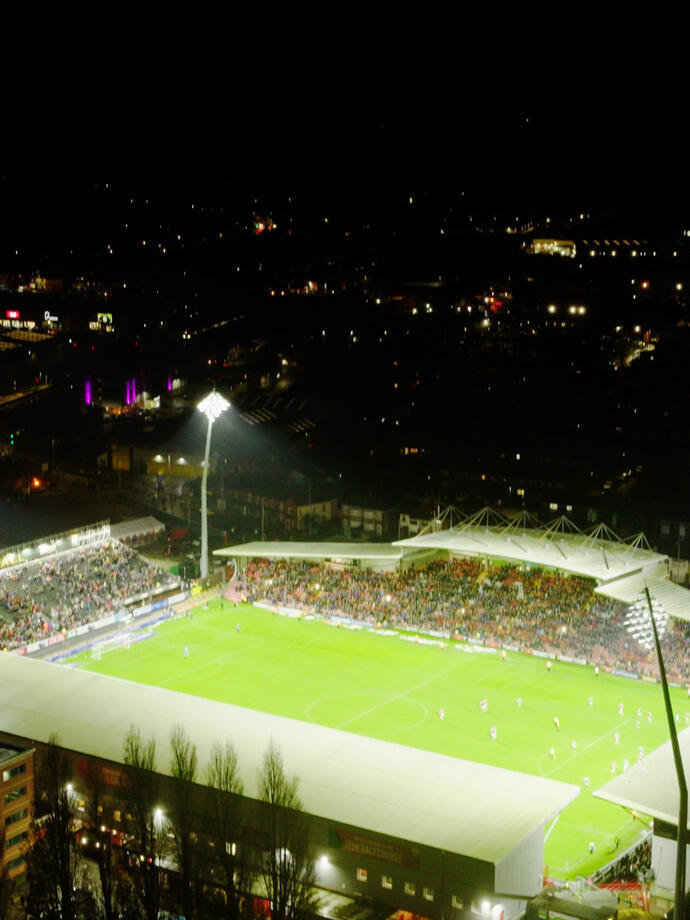 A packed football stadium at night