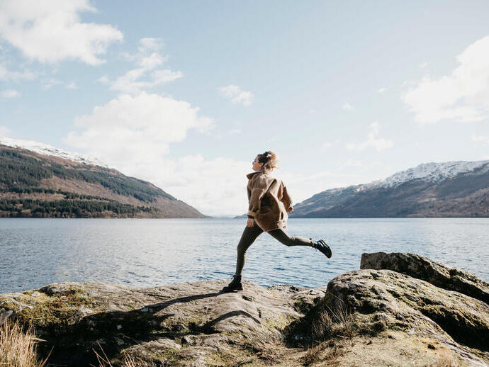 UK, Scotland, young woman running at Loch Lomond