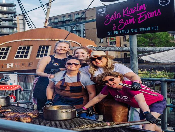 Group of ladies in aprons Hangfire Bbq cooking at Meatopia Food Festival