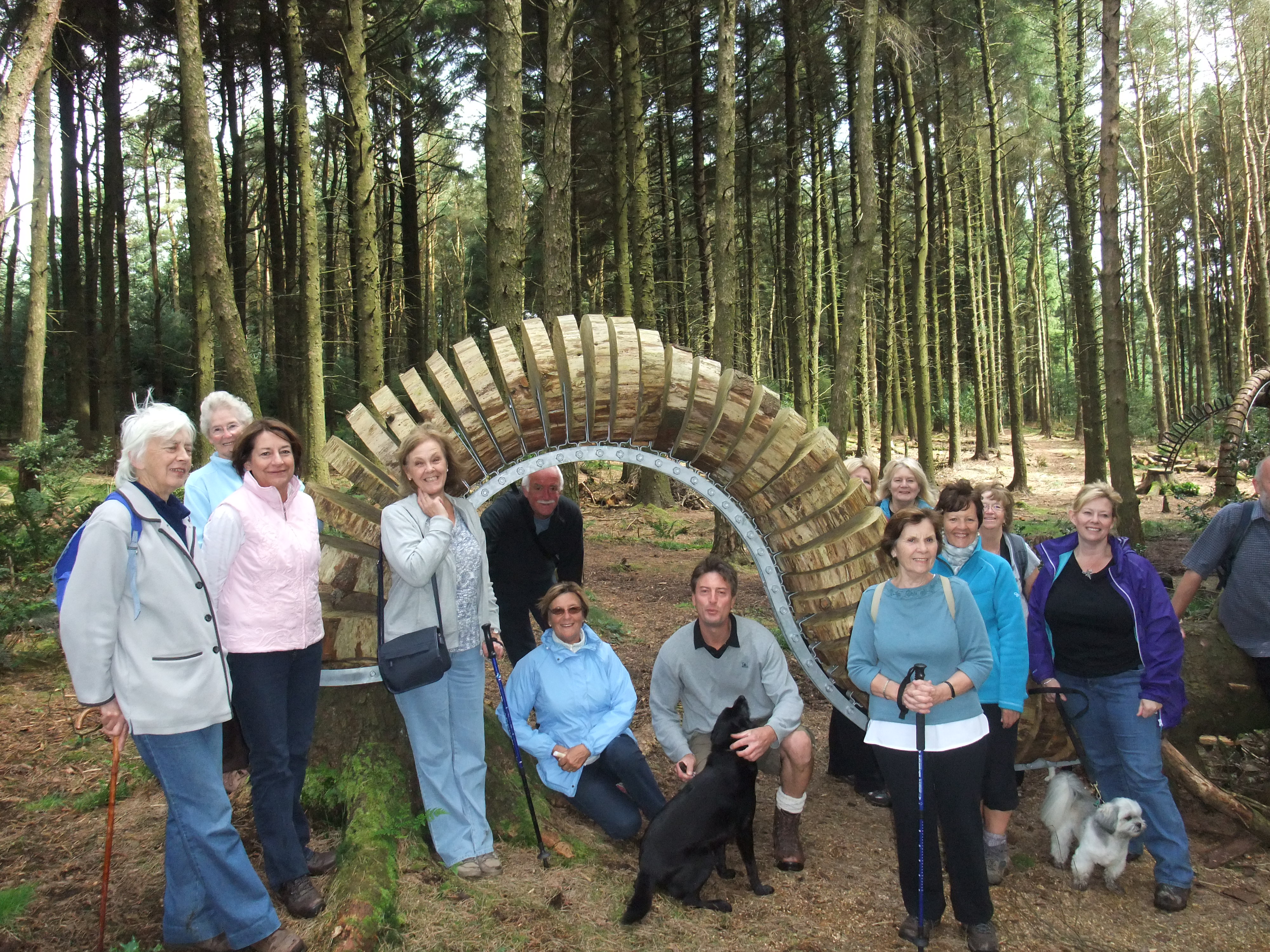 A group of people posing next to a sculpture on the Pendle Sculpture Trail