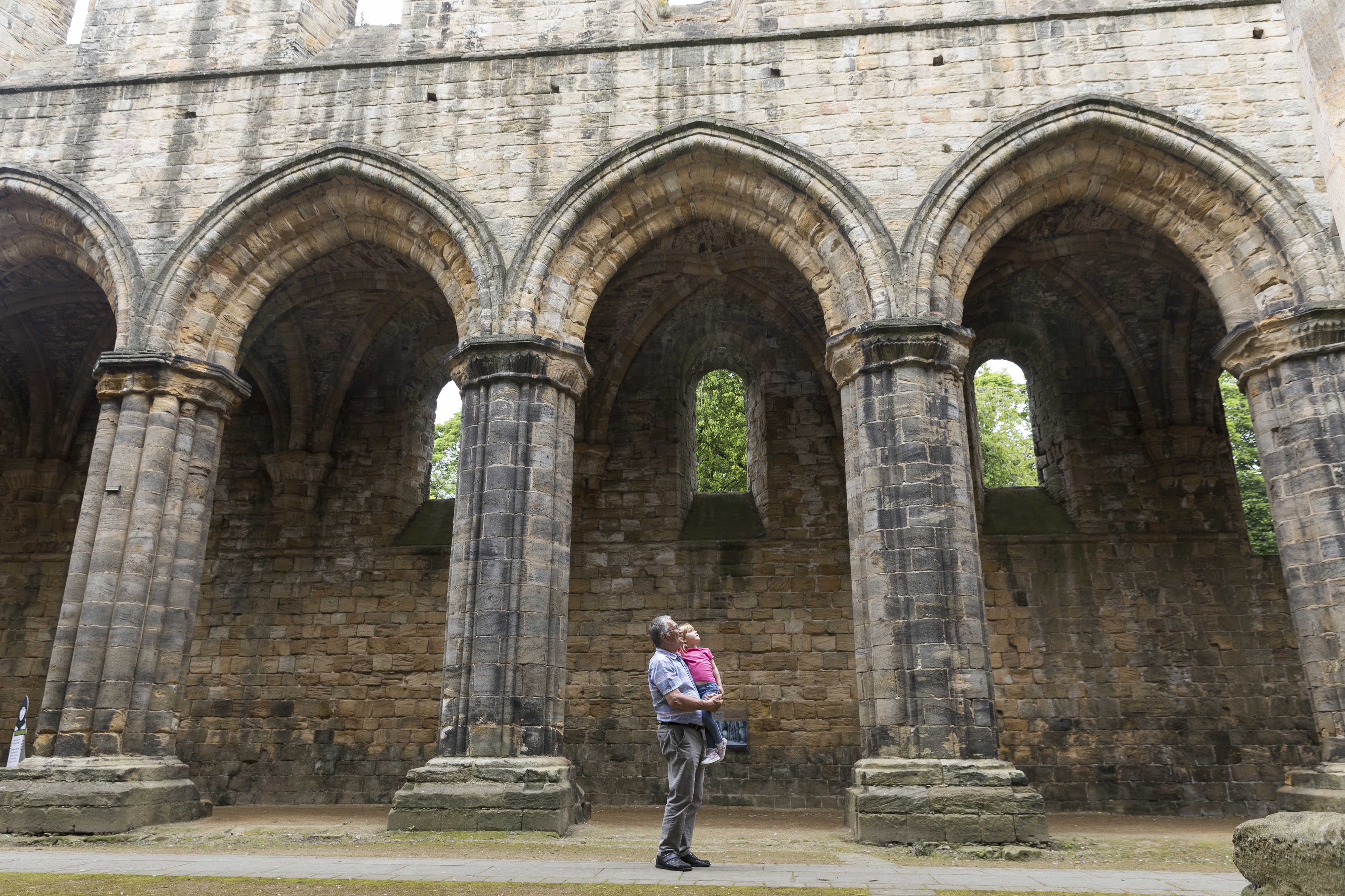 A parent and child exploring Kirkstall Abbey