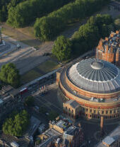 Aerial view of a concert hall and memorial in a park in a city