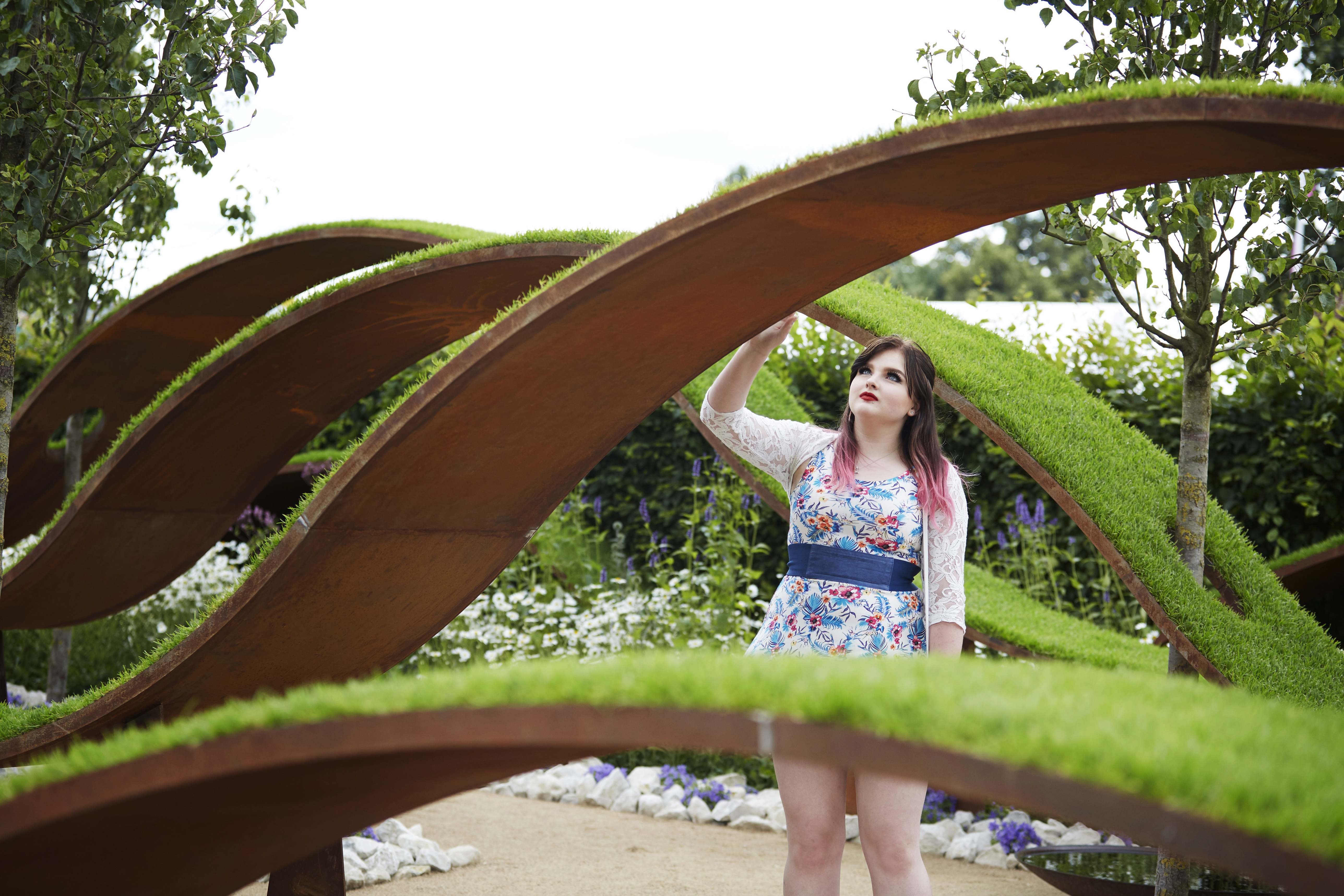 Woman looking at a grass sculpture