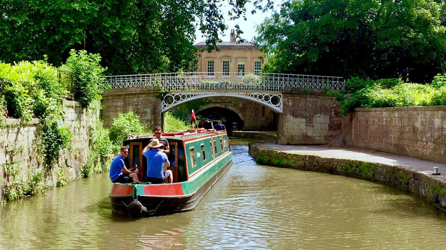 A barge sailing down a canal in Bath
