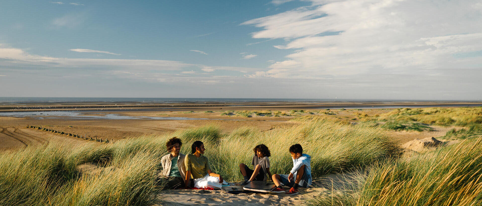 A family enjoy a day out in the sand dunes