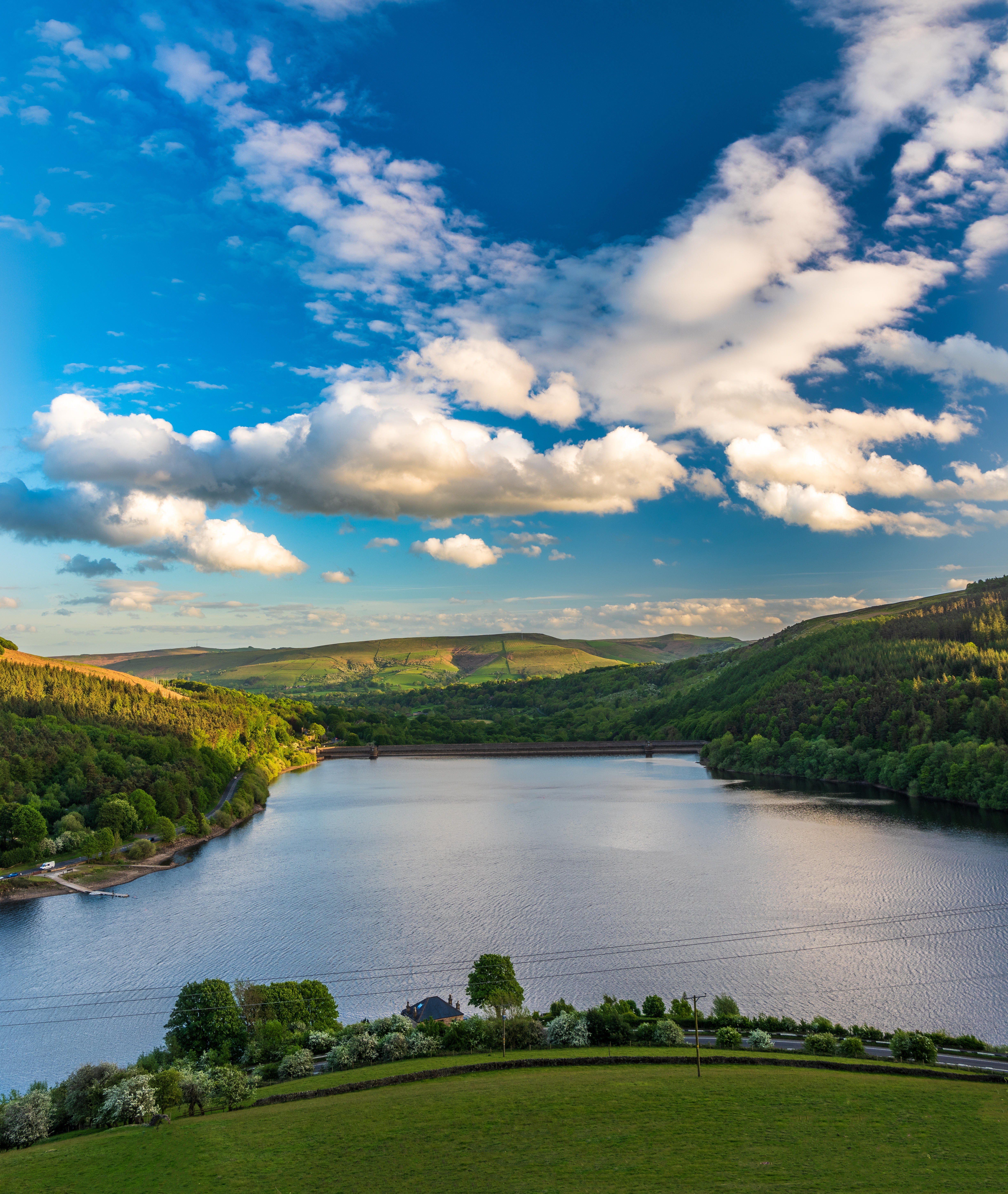 A view over a reservoir with sweeping green hills
