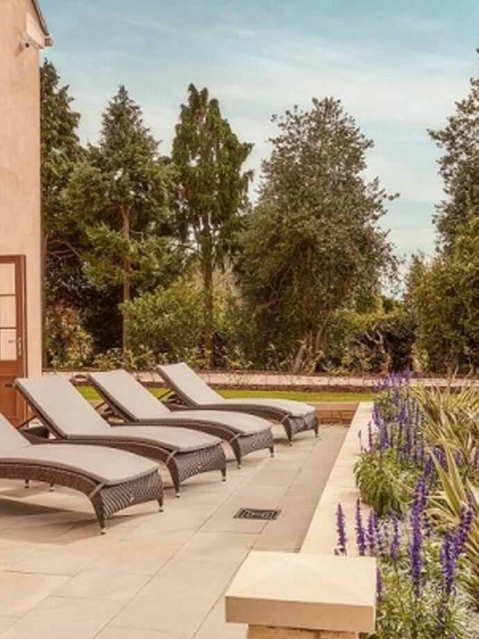 A row of deck chairs outside a luxury hotel and spa resort.
