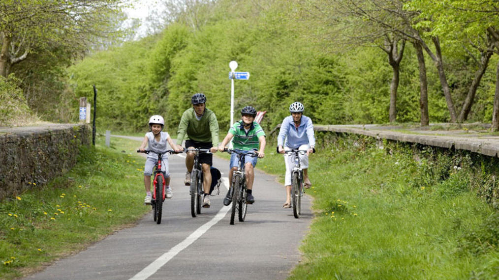 A group of people cycling along a path in Bristol