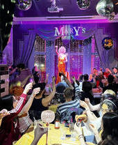 A performer on stage in front of a crowd in Mary's, an LGTBQ+ friendly bar and club in Cardiff.