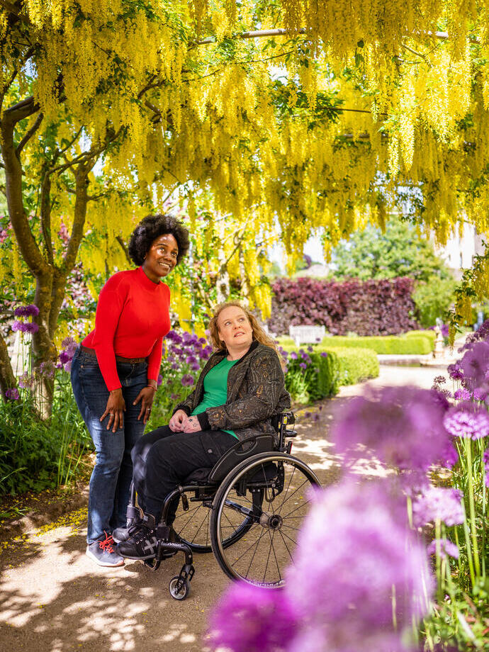 Two women in Helmsley Walled Garden, one using a wheelchair