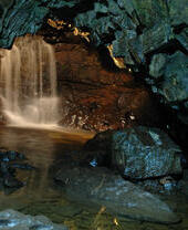 A waterfall cascade inside a cave.