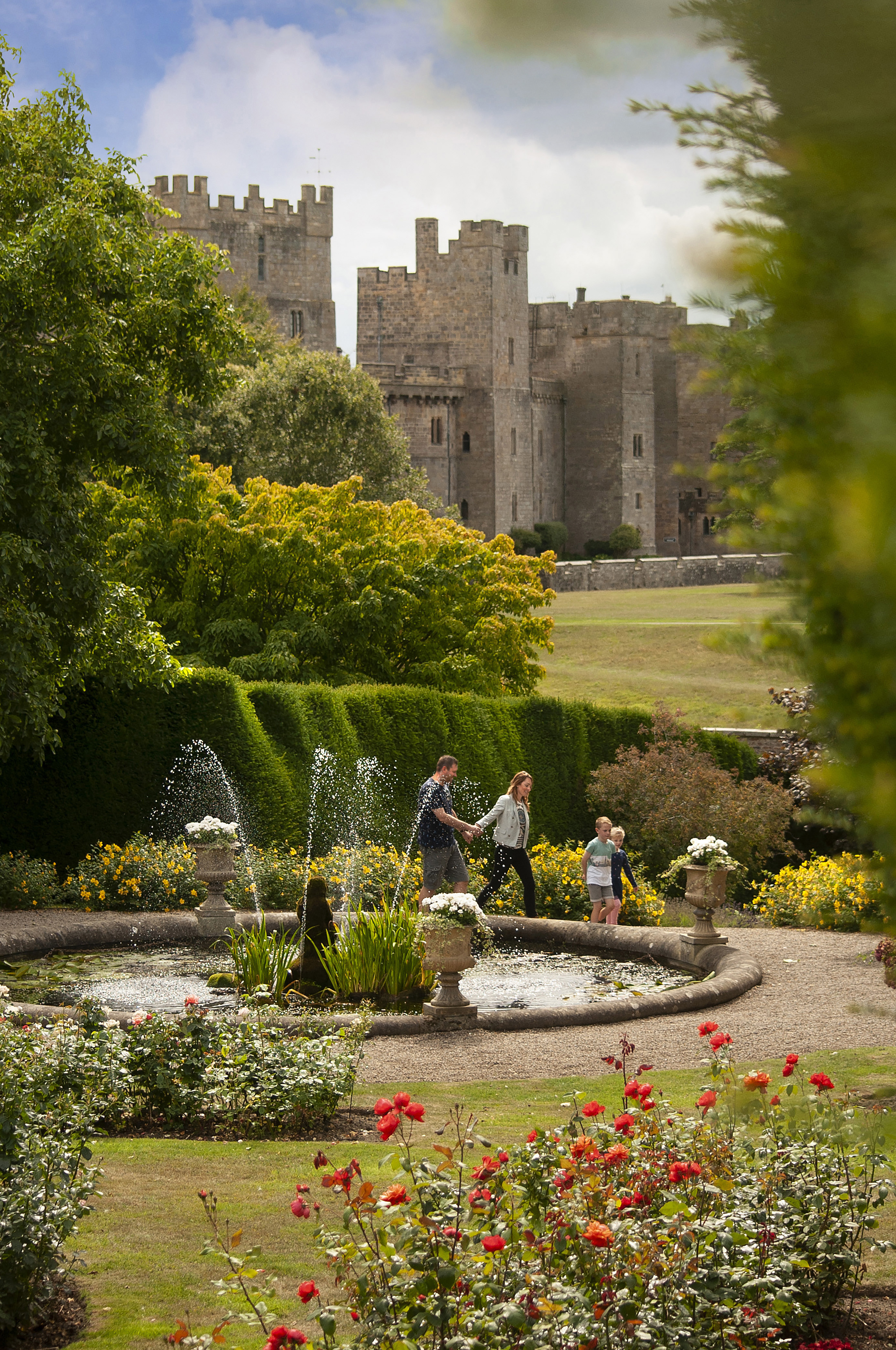 Family walking through the gardens of a castle