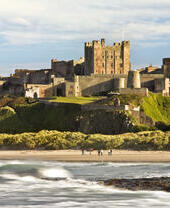 A castle on a cliff by a beach