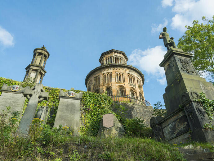 Old building with gravestones in foreground