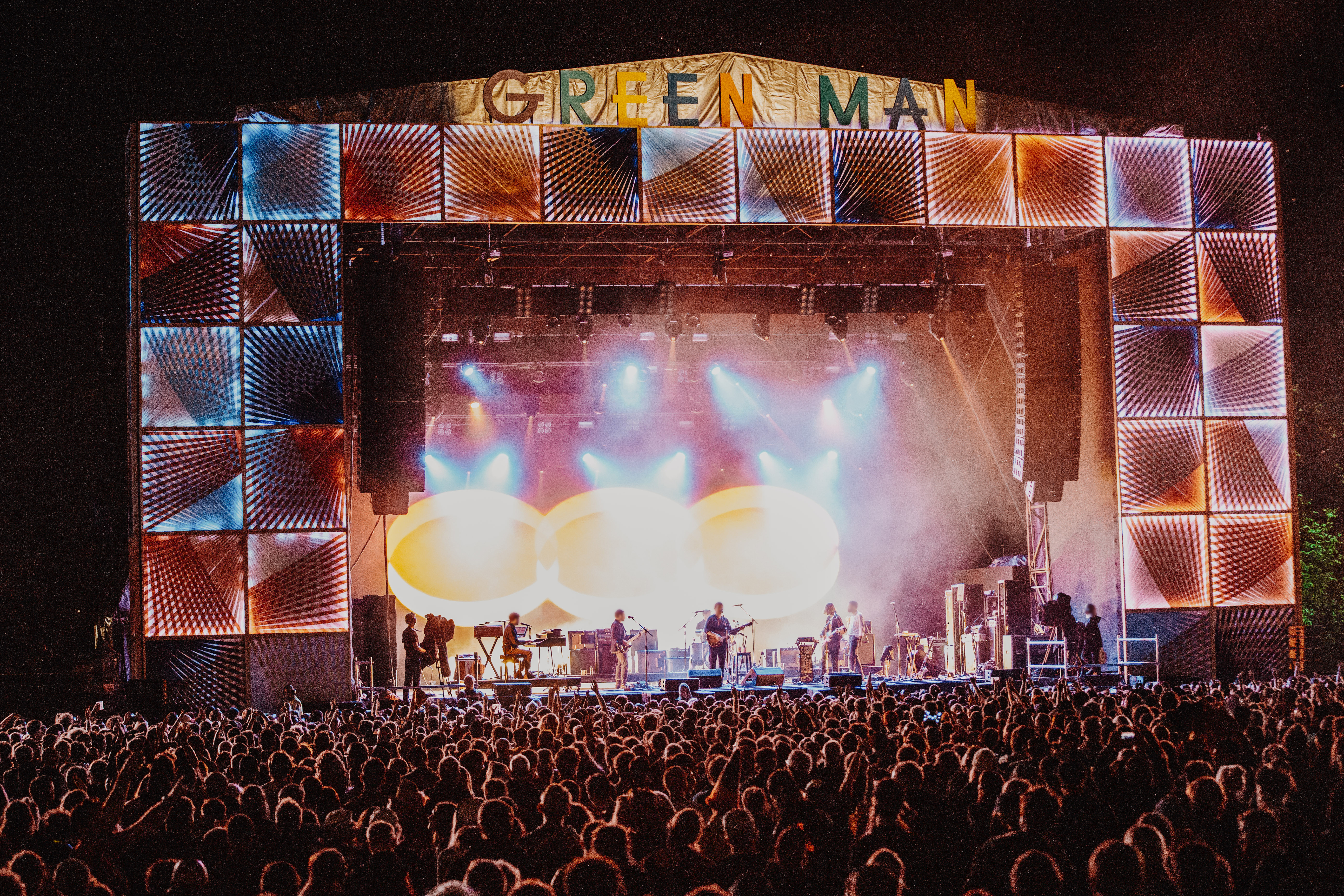 Crowd at a music festival in front of the stage at night