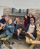 A group of hikers and people sat on tables outside The Skirrid Mountain Inn in Avergavenny, Wales