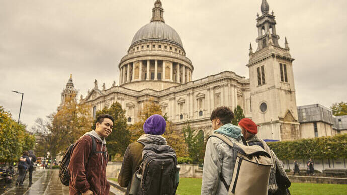 Four people standing in front of a cathedral