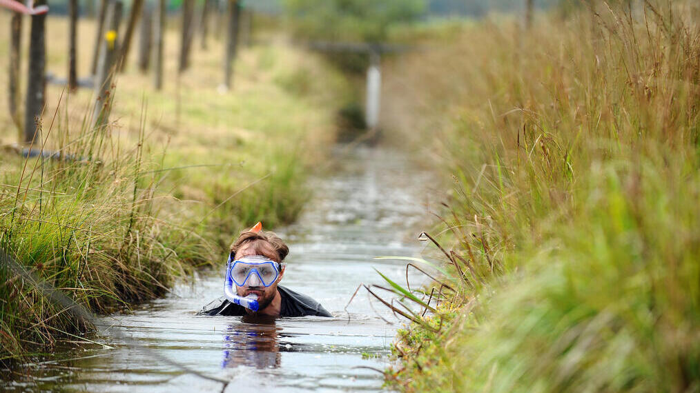 Ein Sumpfschnorchler watet durch einen Kanal
