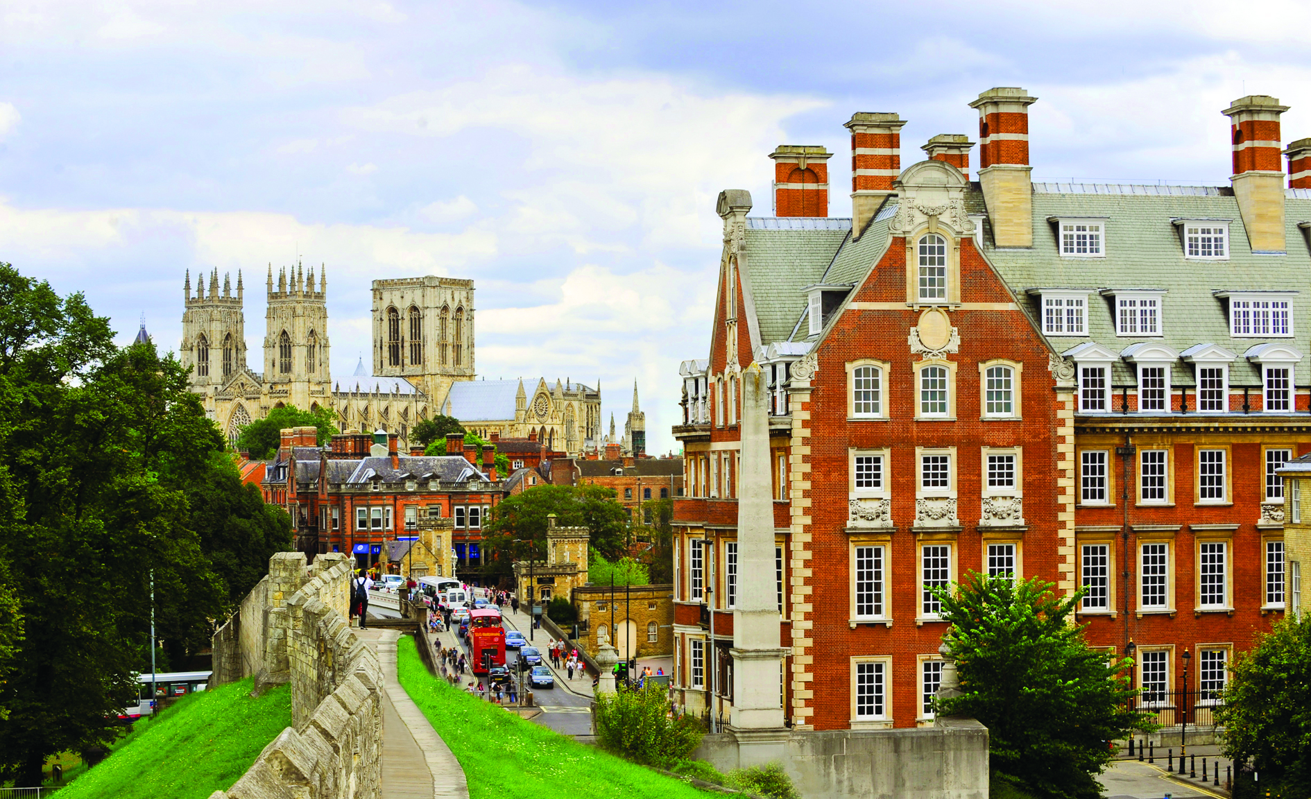 View of the red brick exterior of The Grand Hotel York with the city wall 