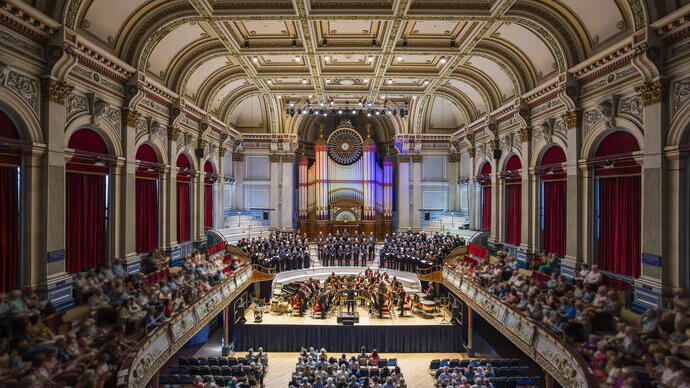 Interior of an impressive hall with an orchestra and audience