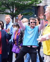 A group of people on an outdoor Silent Disco in London's West End