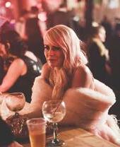 A woman sat at a table with a drink at Depot in Cardiff