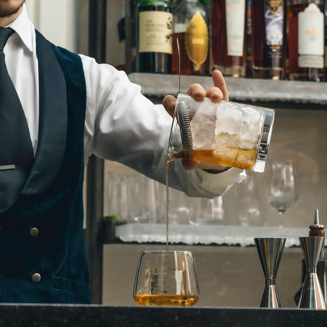 Bartender pouring a whisky drink at the Lakes Distillery