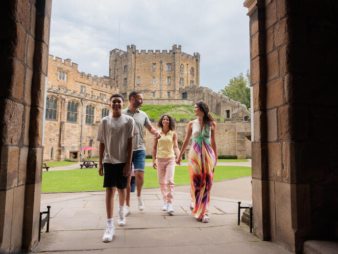 Family walking through an arch in the grounds of a cathedral