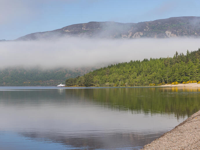 View of lake shore with mountain in the background