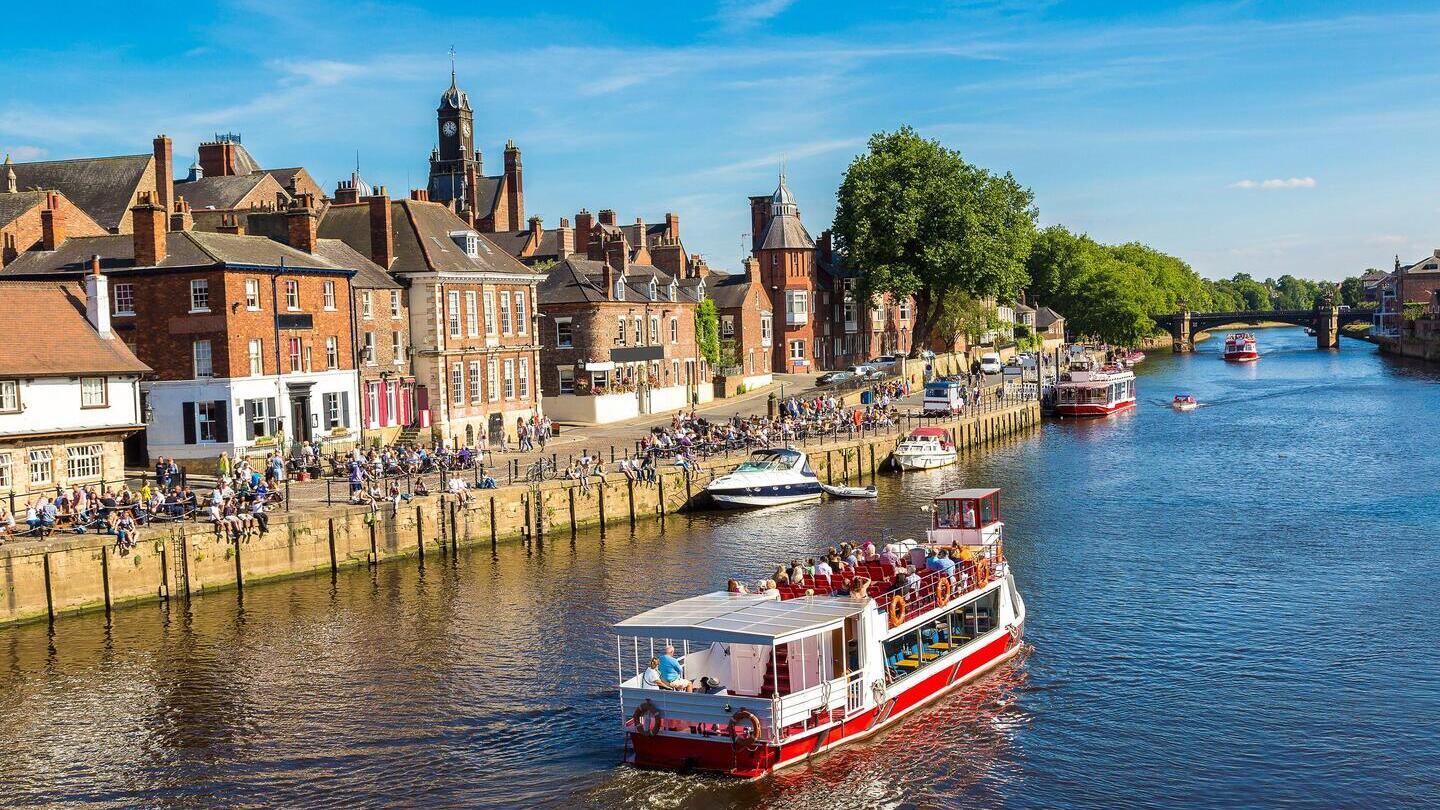 A cruise ship travelling down the River Ouse in York