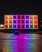 A colourful light installation at night.