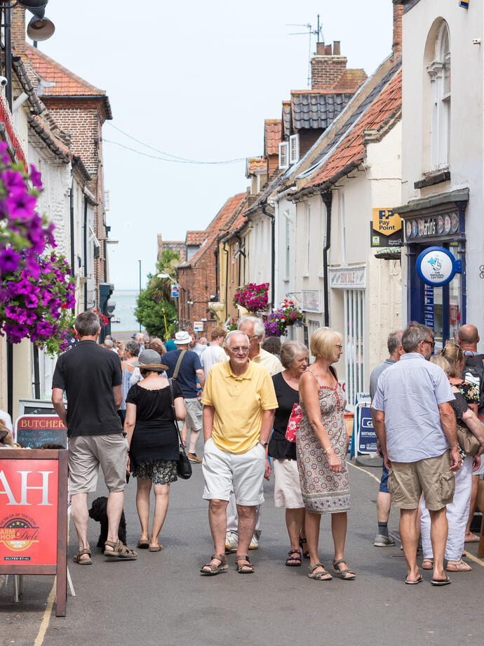 People walking through a shopping street in Wells-next-the-Sea