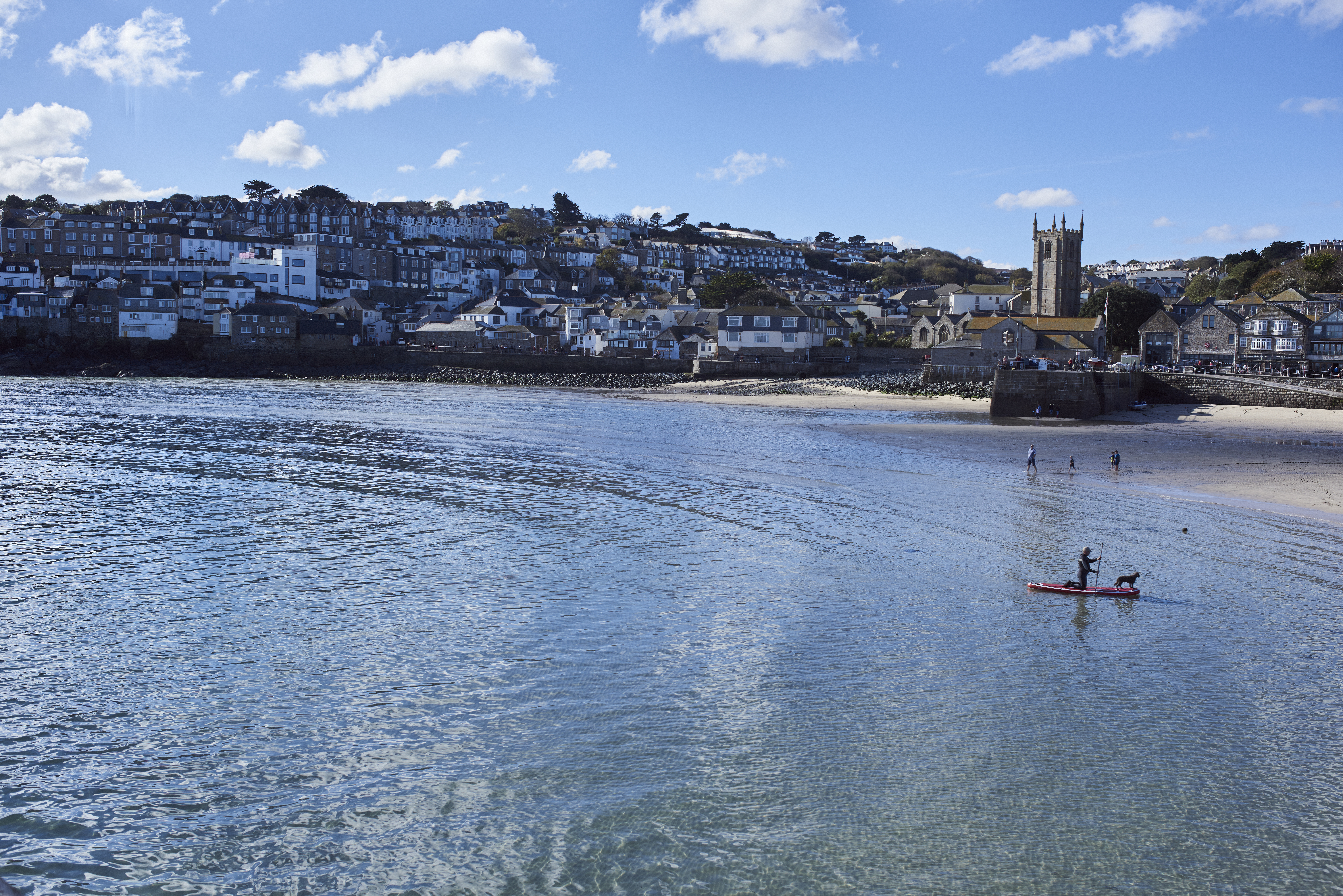 Distant view of sea and harbour with people in orw boats