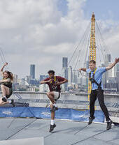 Three people jumping on the roof of the O2 Arena
