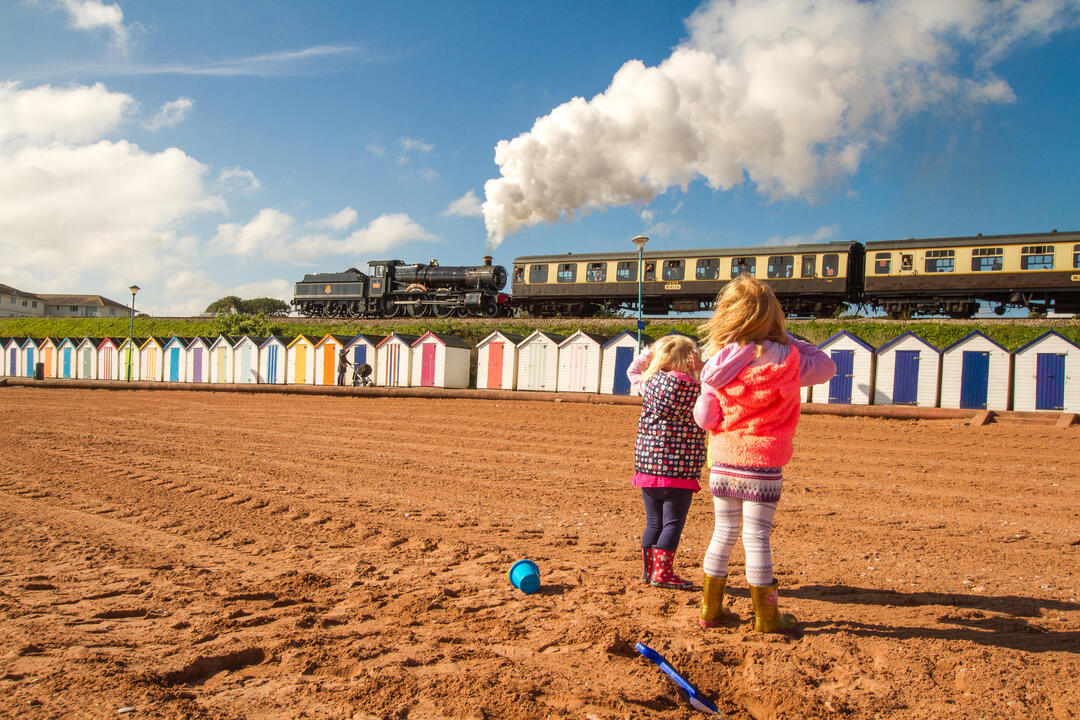 beach huts, steam train railway seaside summer at Paignton