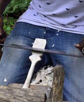 A person carving an object out of wood