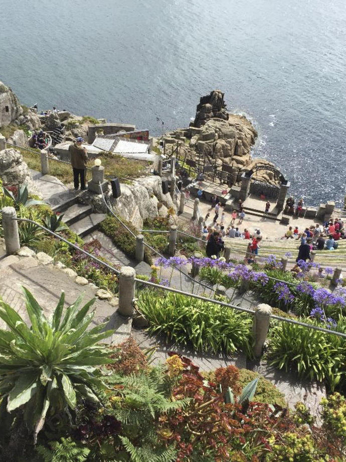 A stone theatre built into the cliff by the sea