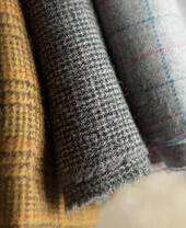 Close up variety of types of Harris Tweed showing the range of fabric available.