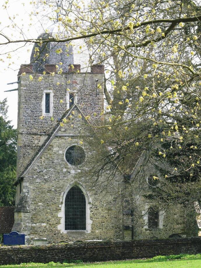 Old Saxon church with blossom tree in the foreground