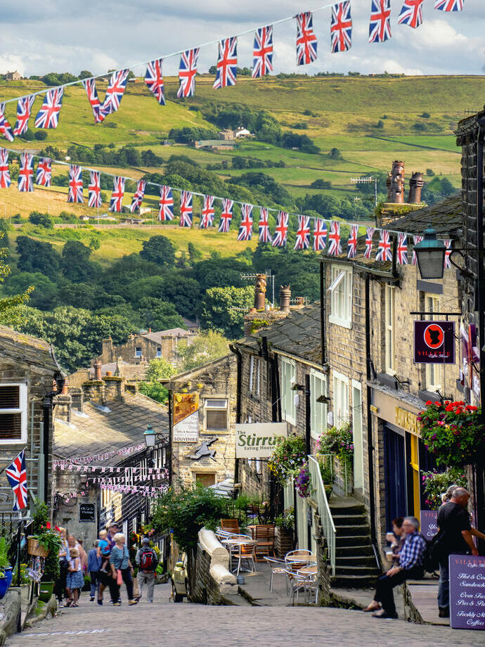 View down cobbled hill in a village with Union Jack bunting