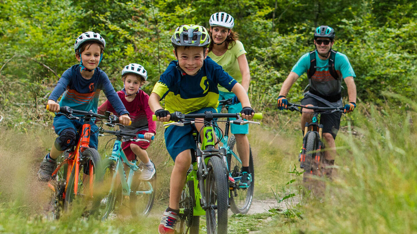 A group of children and parents cycling through the Leicestershire countryside