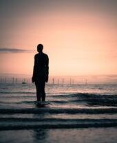 A statue on the beach at high tide