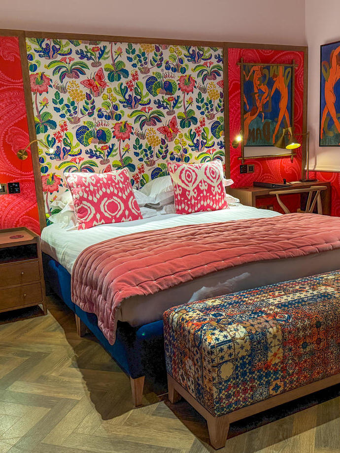 A vibrantly decorated bedroom in an upmarket hotel.