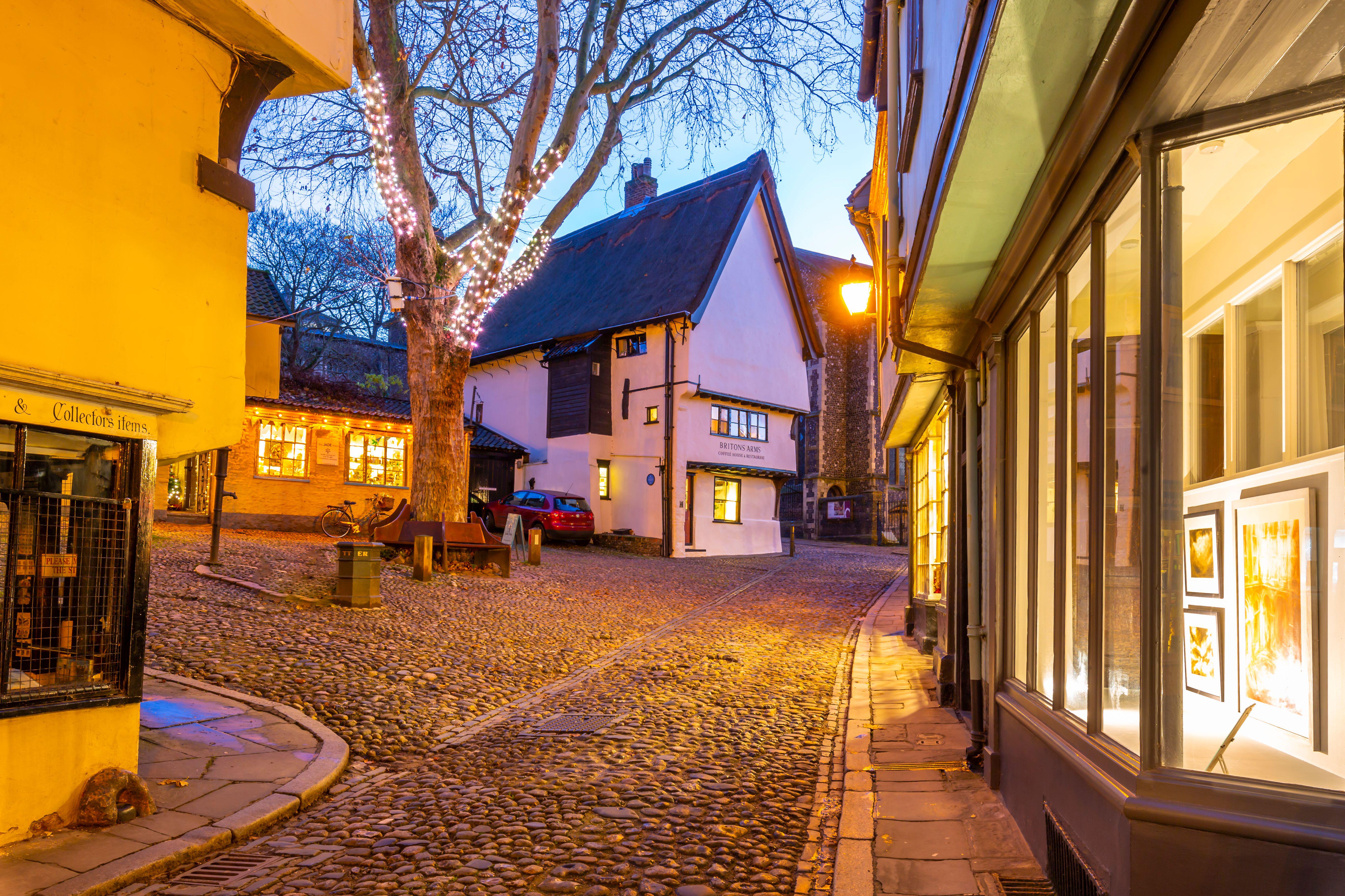 A pretty village square with cobbled streets at dusk