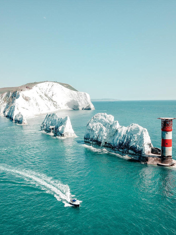 Aerial view of white rock formations standing tall from sea