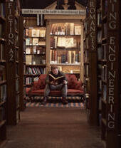 Man in a bookshop, reading a book