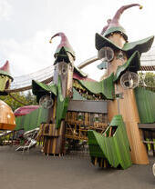 A large playground structure as part of a fantasy themed village in the grounds of a castle