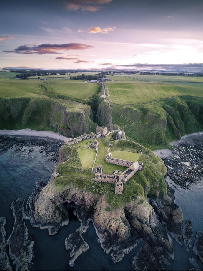 Castle on a rocky outcrop surrounded by sea