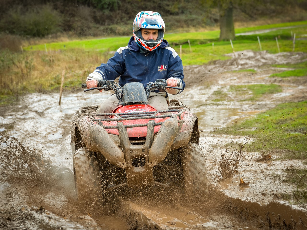 A man riding a quad bike on a muddy track near Stratford-upon-Avon